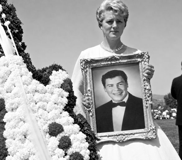 Donna Ludwig holds portrait of Ritchie Valens  in 1959