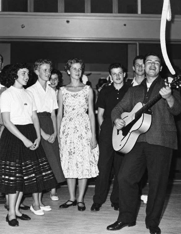 Photo of Ritchie Valens playing the guitar in 1958